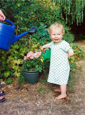 A girl helping her mother in the garden. Stock Photo - Premium Royalty-Free, Code: 6102-03749792