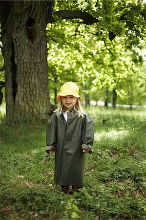 Girl wearing rain clothes in the forest. Stock Photo - Premium Royalty-Free, Code: 6102-03749703