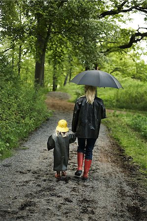 family in rain - Mother and daughter wearing rain clothes, rear view. Stock Photo - Premium Royalty-Free, Code: 6102-03749705