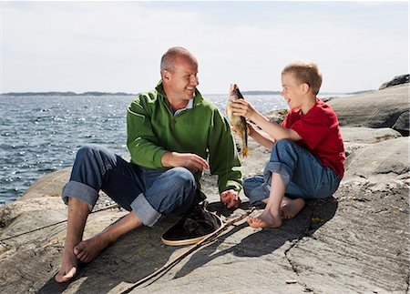 simsearch:6102-03867416,k - Father and son with caught fish. Stock Photo - Premium Royalty-Free, Code: 6102-03749964