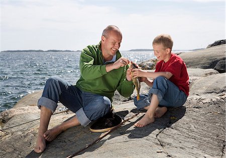 simsearch:6102-03867416,k - Father and son with caught fish. Stock Photo - Premium Royalty-Free, Code: 6102-03749965