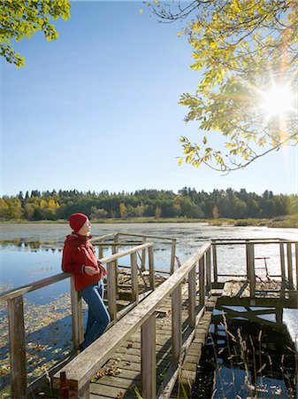 A woman standing on a jetty. Stock Photo - Premium Royalty-Free, Code: 6102-03750028