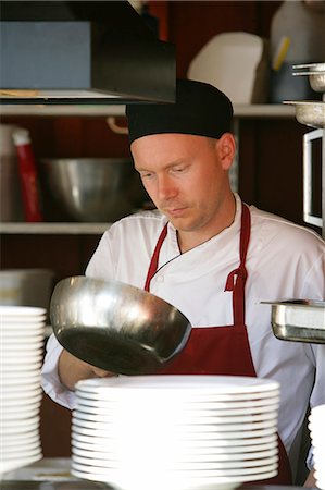 A chef with a frying pan. Stock Photo - Premium Royalty-Free, Code: 6102-03750141