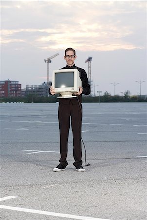 simsearch:6102-08270959,k - A man carrying a computer screen. Stock Photo - Premium Royalty-Free, Code: 6102-03750164