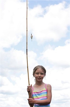 Portrait of a girl holding a fishing rod - Stock Photo - Masterfile -  Premium Royalty-Free, Code: 640-01364295