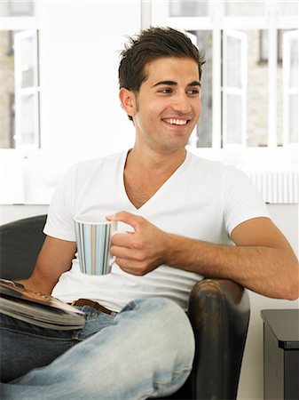 simsearch:6102-08120737,k - A man with a cup and a newspaper in an arm chair. Stock Photo - Premium Royalty-Free, Code: 6102-03750299