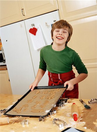 A boy baking gingerbread. Stock Photo - Premium Royalty-Free, Code: 6102-03750436