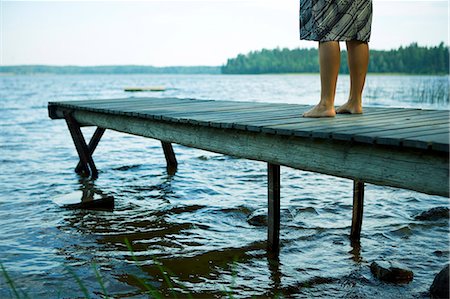 dock on a lake summer feet - A woman standing on a jetty. Stock Photo - Premium Royalty-Free, Code: 6102-03750565