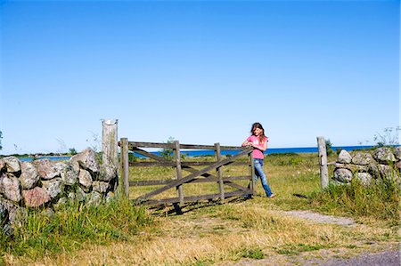 stone walls in meadows - A girl opening a gate. Stock Photo - Premium Royalty-Free, Code: 6102-03750537