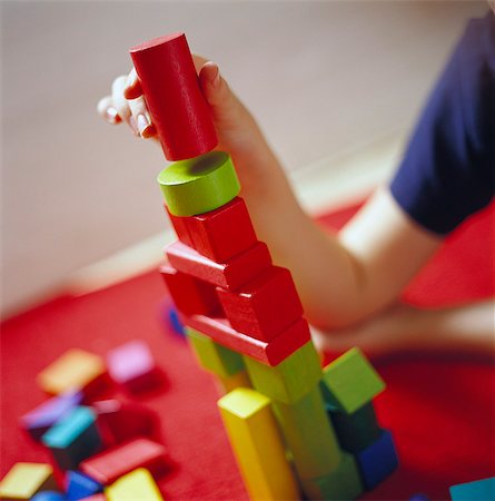 square blocks - Child building a tower using toy bricks, Sweden. Stock Photo - Premium Royalty-Free, Code: 6102-03750748