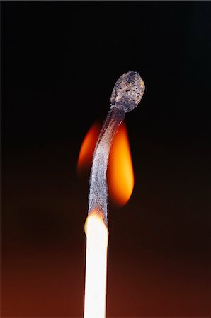 Close-up of flaming match stick against black background Stock Photo - Premium Royalty-Free, Code: 6102-03859110