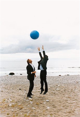 simsearch:6102-03859327,k - Two businessmen in suits playing with ball in beach Stock Photo - Premium Royalty-Free, Code: 6102-03859323