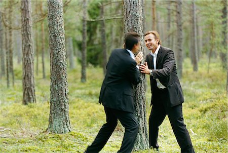 simsearch:6102-03859327,k - Two businessmen messing about in forest Stock Photo - Premium Royalty-Free, Code: 6102-03859333