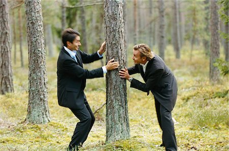 simsearch:6102-03859327,k - Two businessmen messing about in forest Stock Photo - Premium Royalty-Free, Code: 6102-03859334