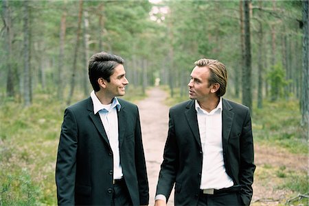 simsearch:6102-03859327,k - Two businessmen walking on path in forest, talking Stock Photo - Premium Royalty-Free, Code: 6102-03859403