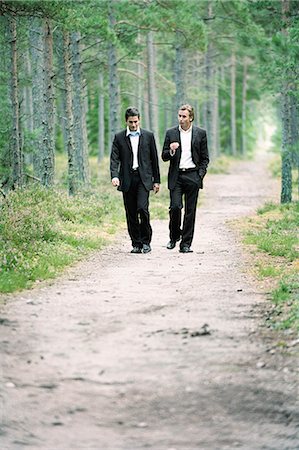 simsearch:6102-03859327,k - Two businessmen walking on path in forest, talking Stock Photo - Premium Royalty-Free, Code: 6102-03859402