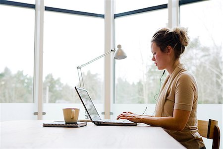 simsearch:6102-03828834,k - A woman using a laptop, Sweden. Stock Photo - Premium Royalty-Free, Code: 6102-03865857