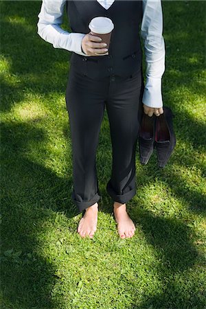 A barefooted businesswoman standing on the grass, Stockholm, Sweden. Foto de stock - Sin royalties Premium, Código: 6102-03865968