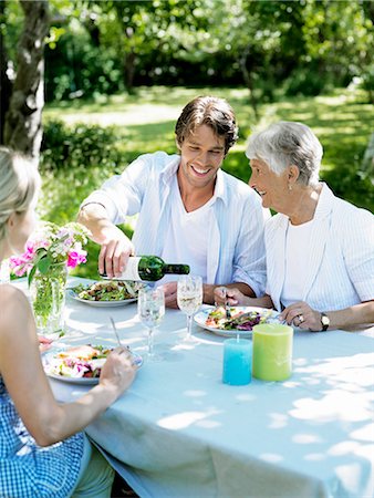 family eating back yard summer - A family having dinner outdoors, Stockholm, Sweden. Stock Photo - Premium Royalty-Free, Code: 6102-03866158