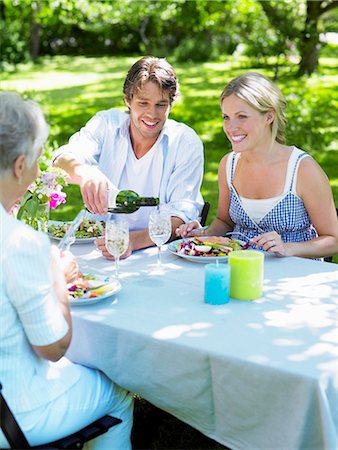 family gathering, holiday - Three persons having dinner in the garden, Stockholm, Sweden. Stock Photo - Premium Royalty-Free, Code: 6102-03866160