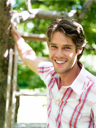 simsearch:6102-03905685,k - A smiling man standing in a garden, Stockholm, Sweden. Stock Photo - Premium Royalty-Free, Code: 6102-03866169