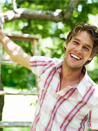 simsearch:6102-03905685,k - A smiling man standing in a garden, Stockholm, Sweden. Stock Photo - Premium Royalty-Free, Code: 6102-03866170