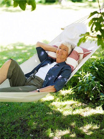 simsearch:6102-08566169,k - An elderly woman resting in a hammock, Stockholm, Sweden. Stock Photo - Premium Royalty-Free, Code: 6102-03866184