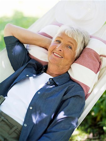 simsearch:6102-07769055,k - An elderly woman in a hammock, Stockholm, Sweden. Stock Photo - Premium Royalty-Free, Code: 6102-03866186