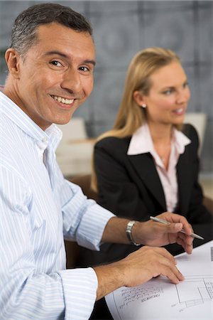 simsearch:6102-07769345,k - A smiling man in during a meeting, Sweden. Stock Photo - Premium Royalty-Free, Code: 6102-03866126