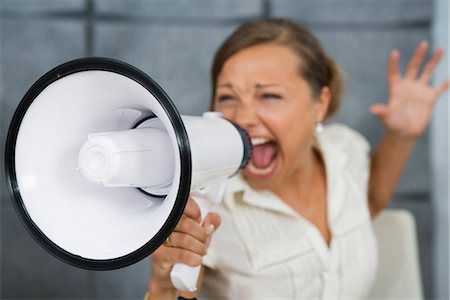 distinctive - A woman yelling in a megaphone in an office, Sweden. Stock Photo - Premium Royalty-Free, Code: 6102-03866137