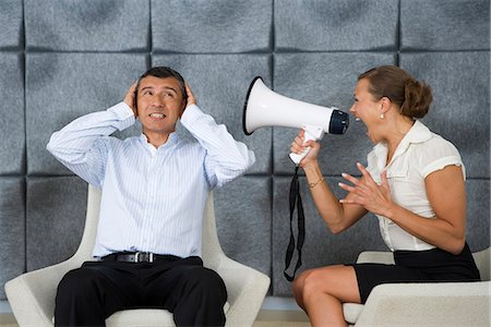 secretary on chair in office - A woman yelling in a megaphone, Sweden. Stock Photo - Premium Royalty-Free, Code: 6102-03866134