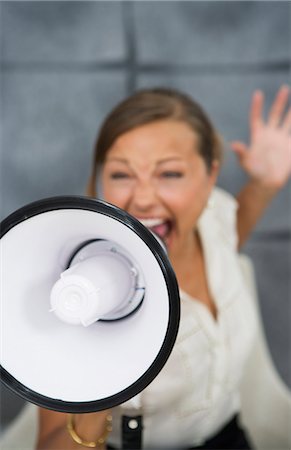 simsearch:6102-06336804,k - A woman yelling in a megaphone in an office, Sweden. Foto de stock - Royalty Free Premium, Número: 6102-03866139