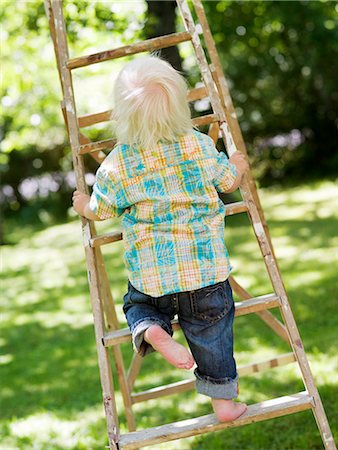 A boy climbing a ladder, Stockholm, Sweden. Stock Photo - Premium Royalty-Free, Code: 6102-03866214