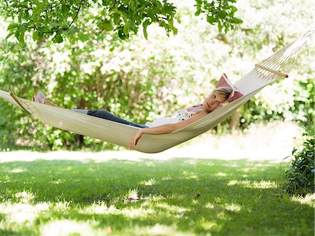 A woman resting in a hammock, Stockholm, Sweden. Stock Photo - Premium Royalty-Free, Code: 6102-03866224