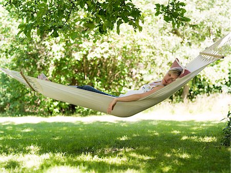 sleeping backyard - A woman resting in a hammock, Stockholm, Sweden. Stock Photo - Premium Royalty-Free, Code: 6102-03866225