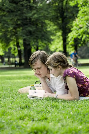 A young couple laying in the grass in a park, Sweden. Stock Photo - Premium Royalty-Free, Code: 6102-03866356