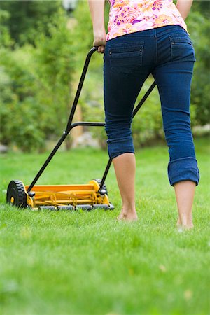 A woman using a lawn mower, Sweden. Stock Photo - Premium Royalty-Free, Code: 6102-03866786