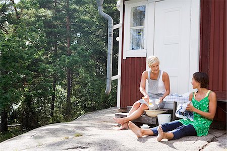 Two women washing the dishes outside a summer day, Sweden. Stock Photo - Premium Royalty-Free, Code: 6102-03866849