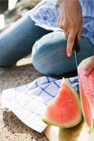 A woman cutting up a watermelon, Sweden. Stock Photo - Premium Royalty-Free, Code: 6102-03866867