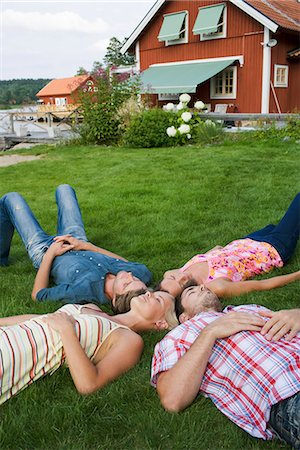 friends sleeping together - Four people lying on a lawn, Sweden. Stock Photo - Premium Royalty-Free, Code: 6102-03866813