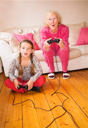 family electricity - An elderly woman playing video game with her granddaughter, Sweden. Stock Photo - Premium Royalty-Free, Code: 6102-03866903