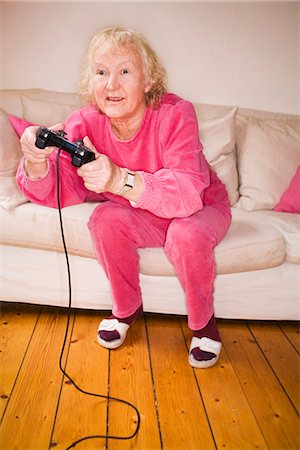 simsearch:6102-08566169,k - An elderly woman playing a video game, Sweden. Stock Photo - Premium Royalty-Free, Code: 6102-03866905