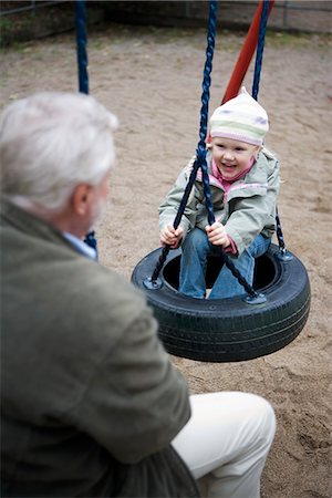 Grandfather and grandchild playing together on a playground, Sweden. Stock Photo - Premium Royalty-Free, Code: 6102-03867087