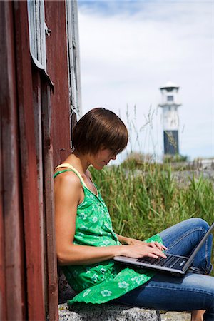 simsearch:6102-03828834,k - A scandinavian woman sitting by a house in the archipelago, Sweden. Stock Photo - Premium Royalty-Free, Code: 6102-03867234