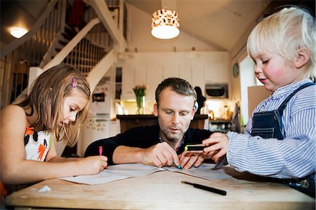 Father, son and daughter painting together, Sweden. Stock Photo - Premium Royalty-Free, Code: 6102-03867394