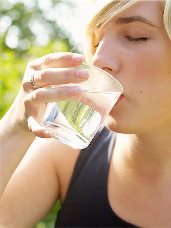 A young woman drinking water, Sweden. Stock Photo - Premium Royalty-Free, Code: 6102-03867316