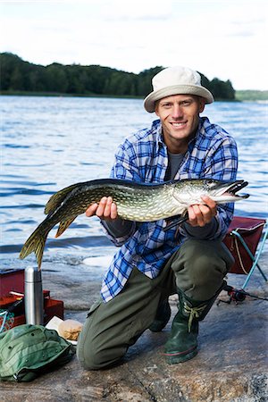 fish men - A man holding a pike, Sweden. Stock Photo - Premium Royalty-Free, Code: 6102-03867416