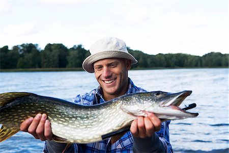 A man holding a pike, Sweden. Stock Photo - Premium Royalty-Free, Code: 6102-03867419