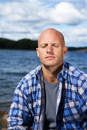 simsearch:6102-03867416,k - Portrait of a smiling man by the water, Sweden. Stock Photo - Premium Royalty-Free, Code: 6102-03867422