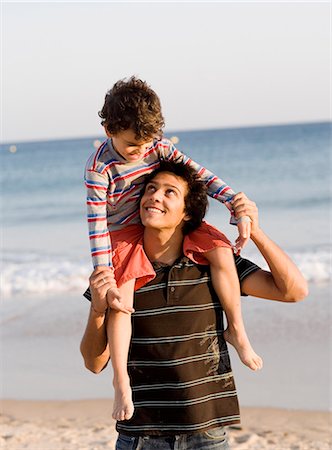 piggyback brothers - Brothers playing on a beach, Portugal. Stock Photo - Premium Royalty-Free, Code: 6102-03867644